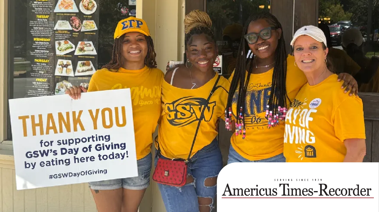 students in gold shirts smiling