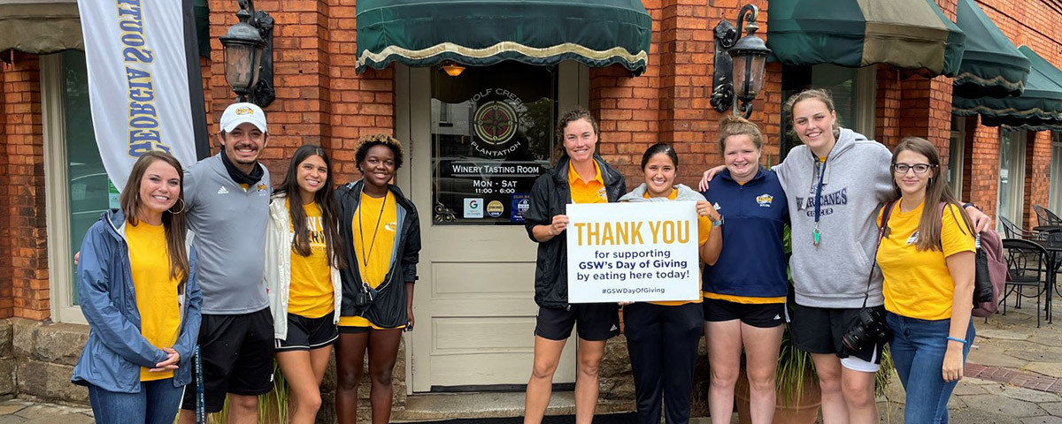 students and staff hold thank you sign