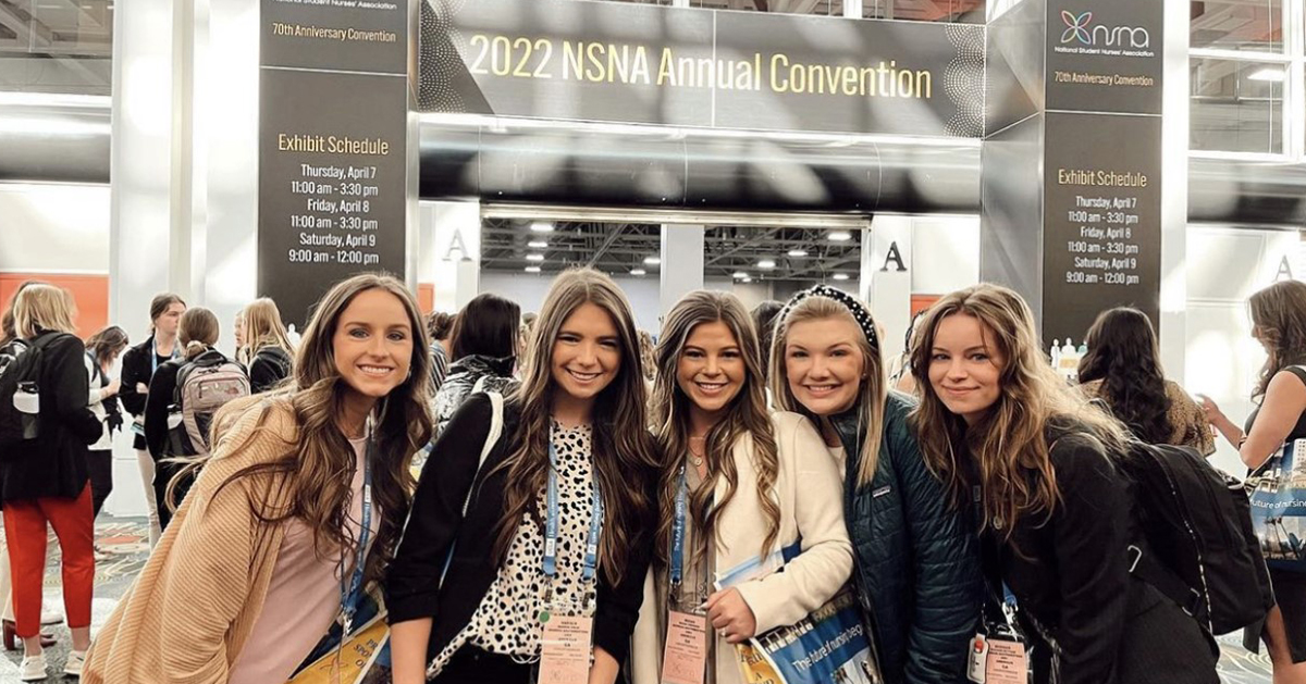 nursing students in front of convention entrance