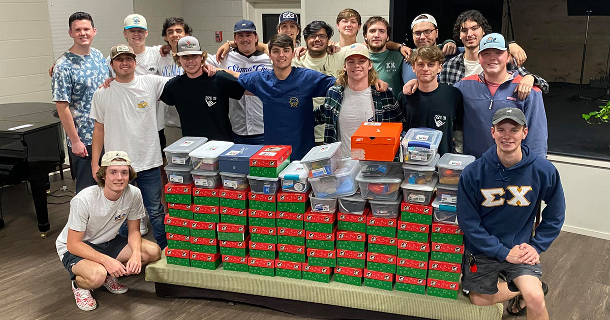 Sigma Chi brothers with packed boxes
