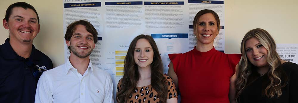 Parker Munn, Tyler Cobb, Lindsey Alford, Janice Goodin, and Jada Barfield in front of their poster