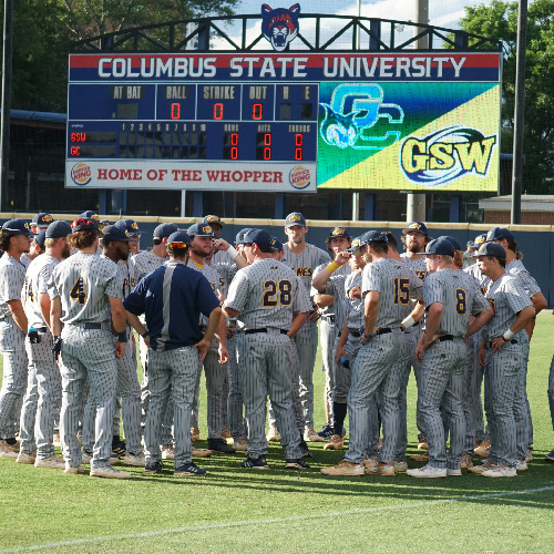 baseball team gathers on field