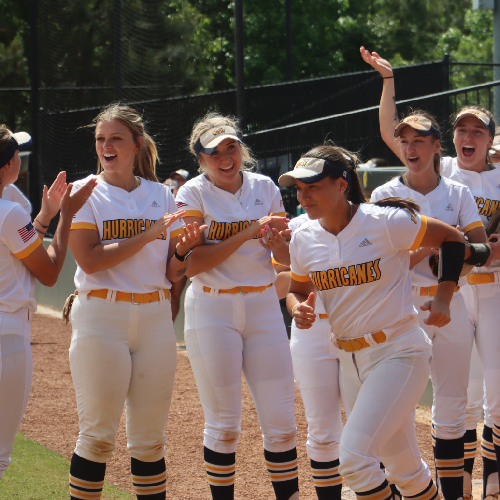 softball team celebrates on the field