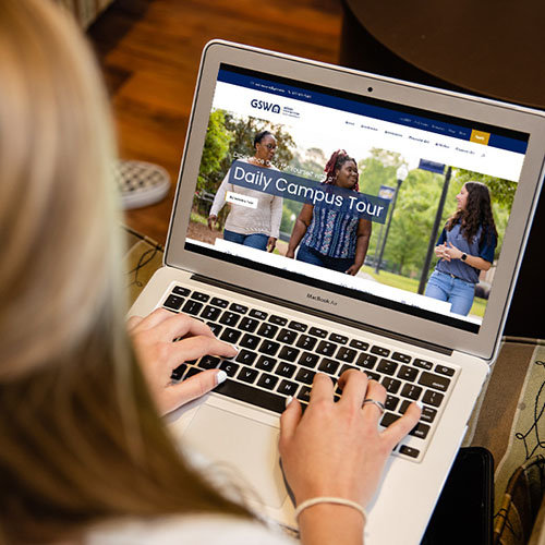 girl uses GSW website on laptop