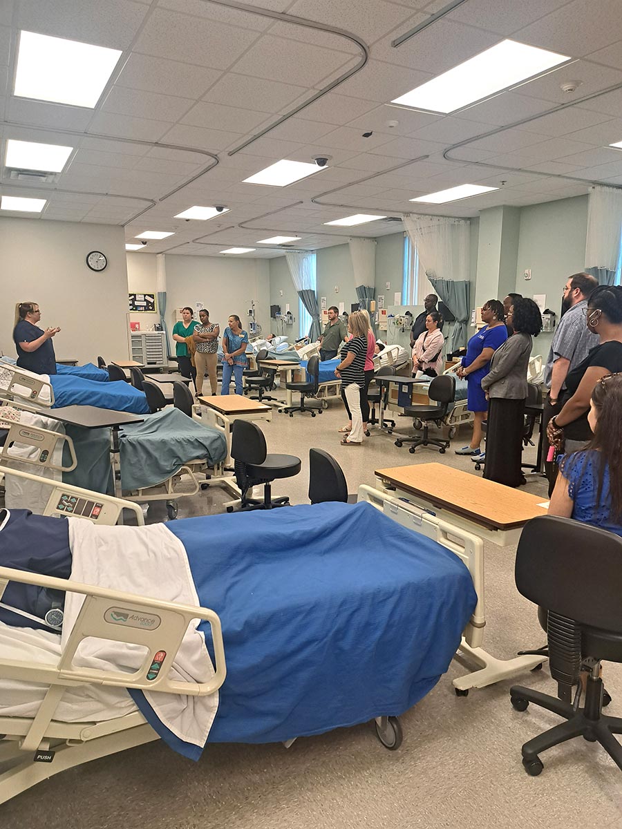 Employees gather to learn more about GSW's nursing simulators.