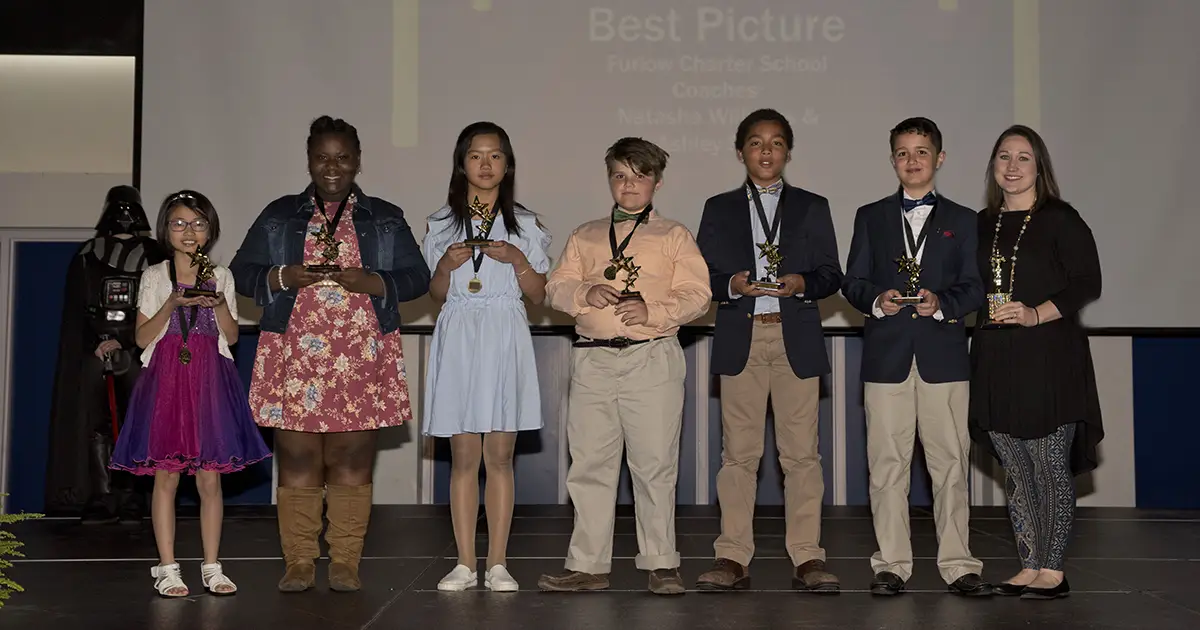 students with trophies
