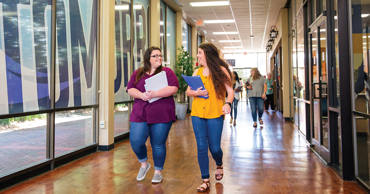 students walk down hallway