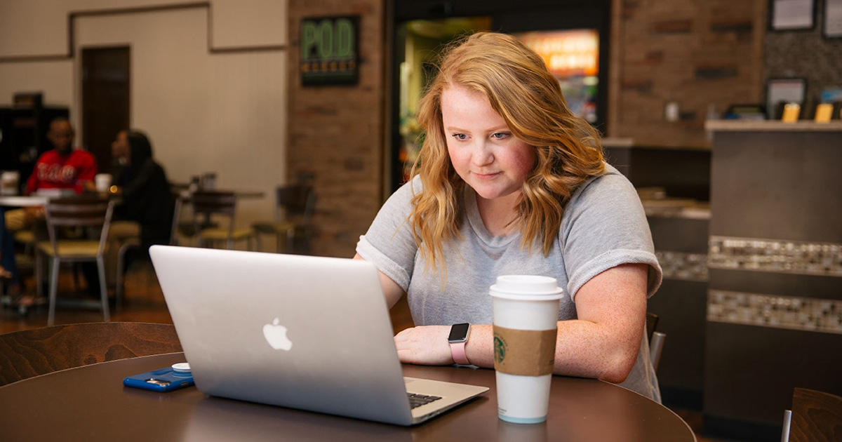 female student using laptop