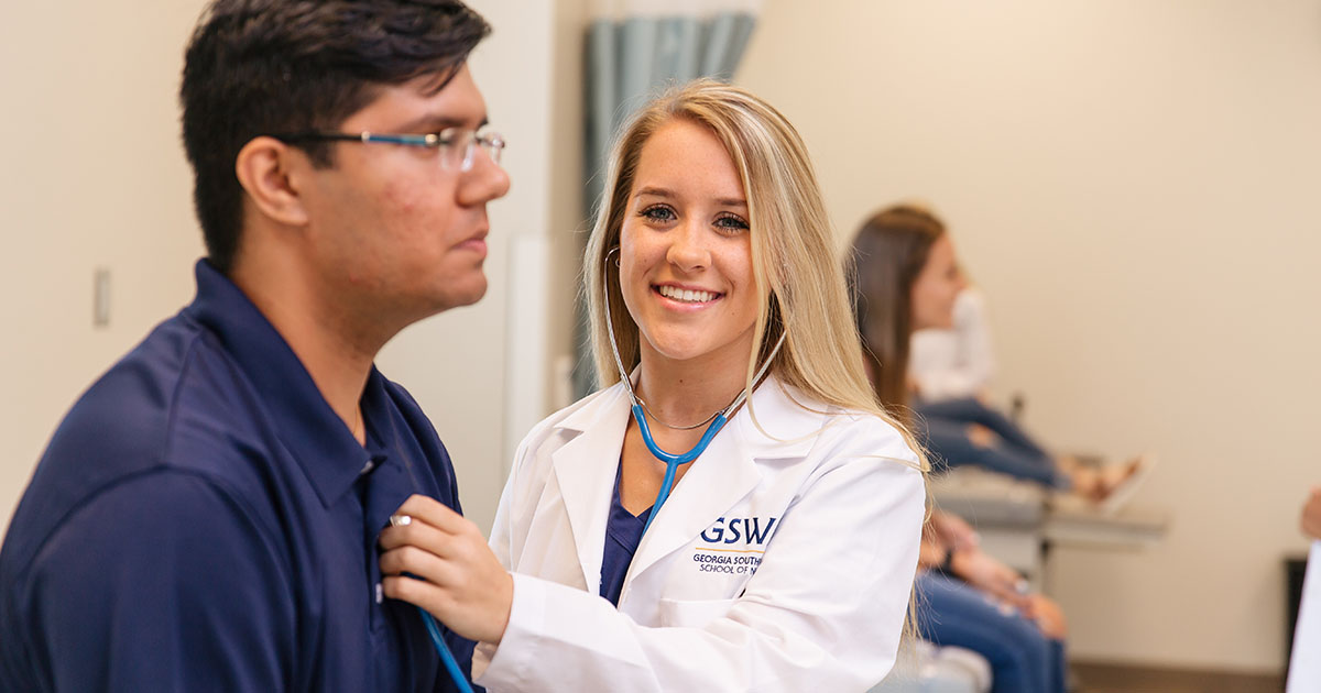 nursing student checks patients heart