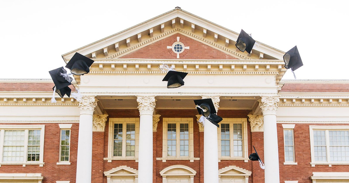 graduation caps thrown in the air