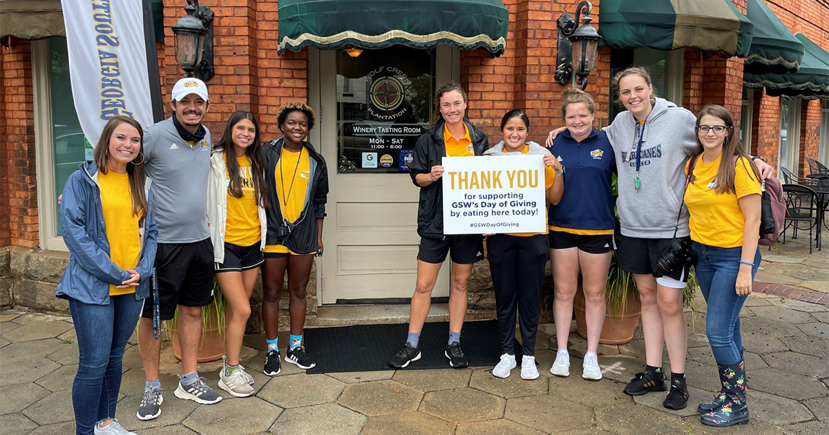 Participants during Day of Giving in front of local restaurant