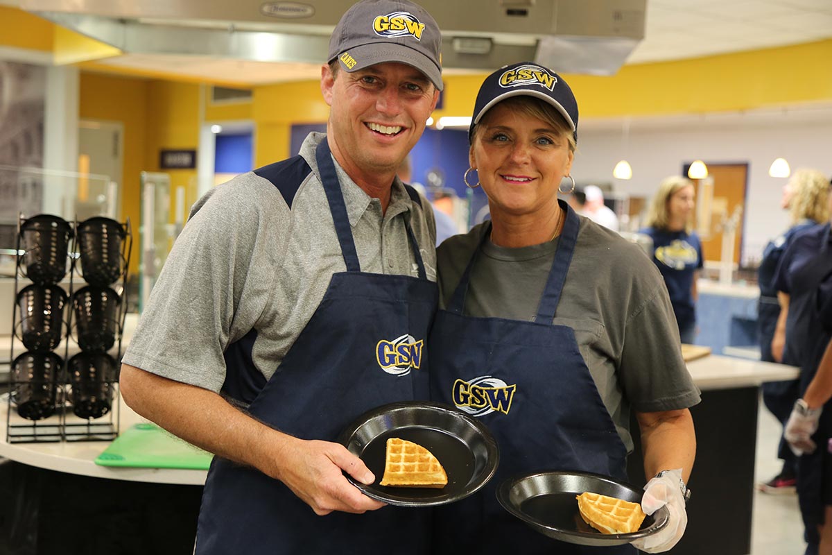 Dr. Neal Weaver and wife Kristi serve waffles at the biannual Waffles with the Weavers event during finals week in May 2019