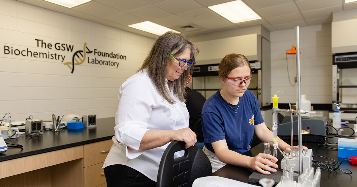 Chemistry Professor guiding student project.