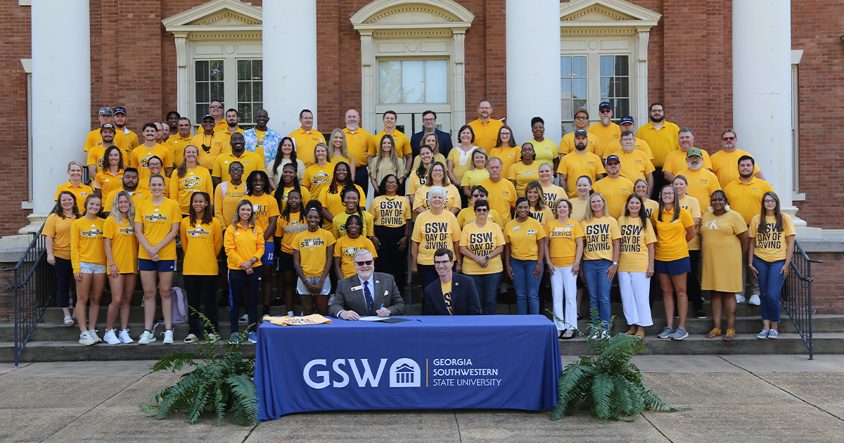GSW faculty, staff, and students stand in front of Wheatley Administration Building while proclamation is signed