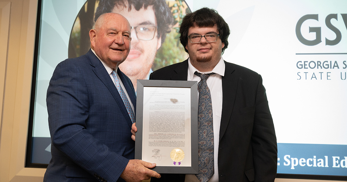 Chancellor Sonny Perdue presents Charles Doswell with his award