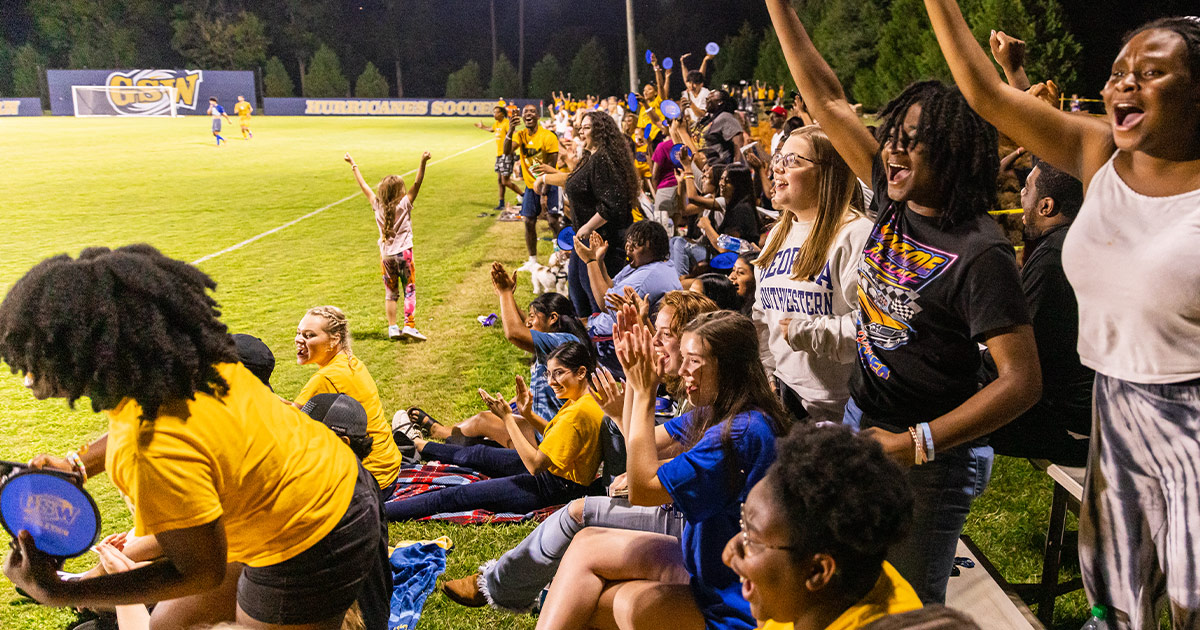 students attending soccer game, homecoming 2022