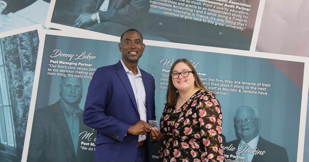 Kaitlyn Evans with Doug Moses, presenting her silver coin