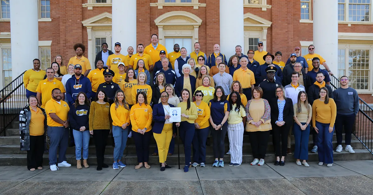 GSW employees wear blue and gold in group photo