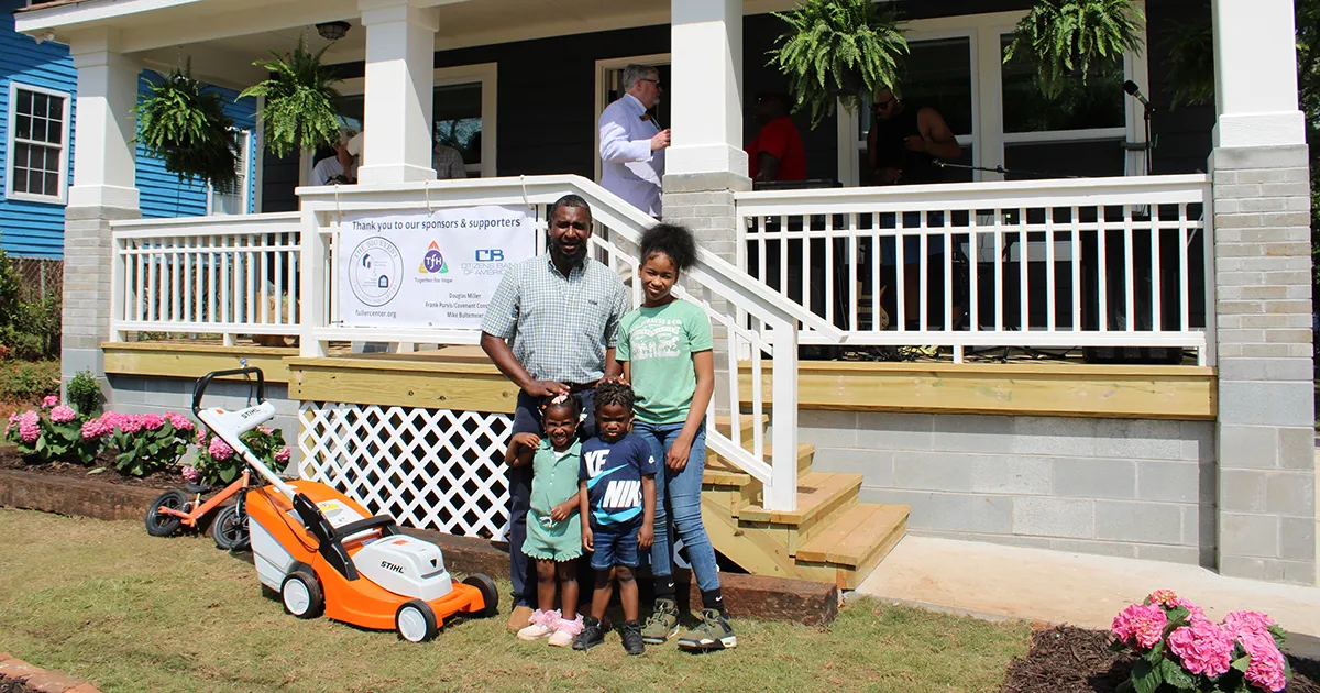 Robinson family in front of their new home