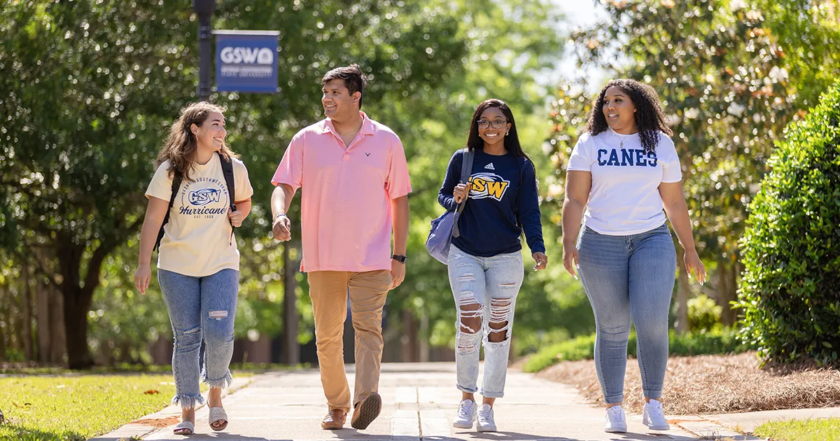 four students walking on campus