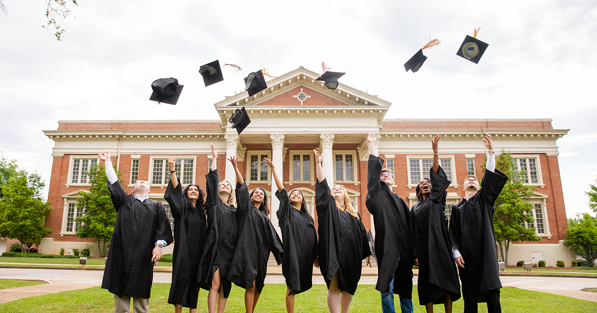 Students tossing graduation caps at GSW