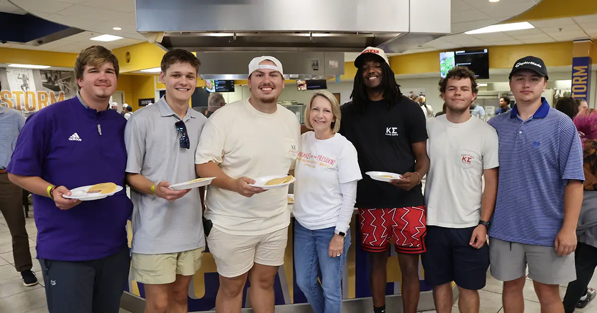 Dr. Johnston standing with students