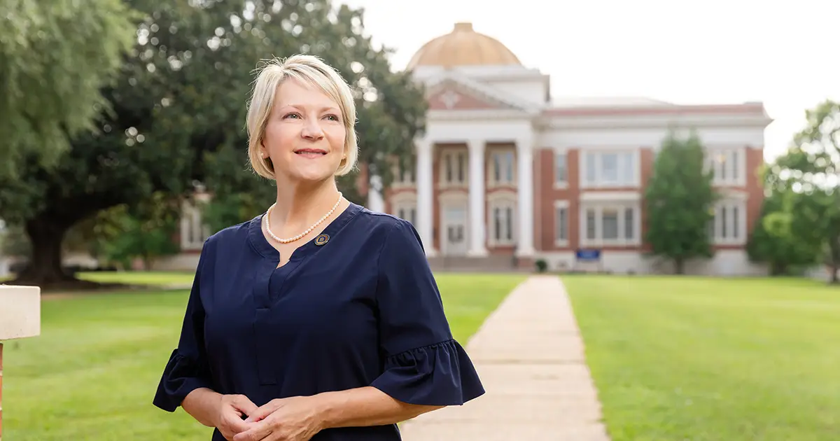 President Johnston on front lawn in front of Admin Building