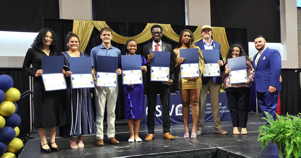 Students holding awards at ceremony