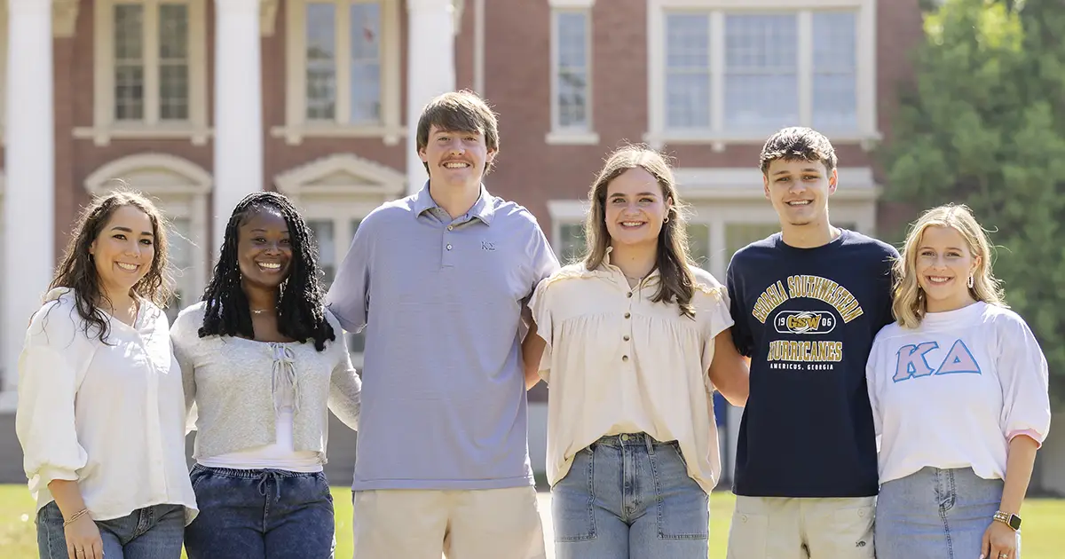 group of students smiling outside